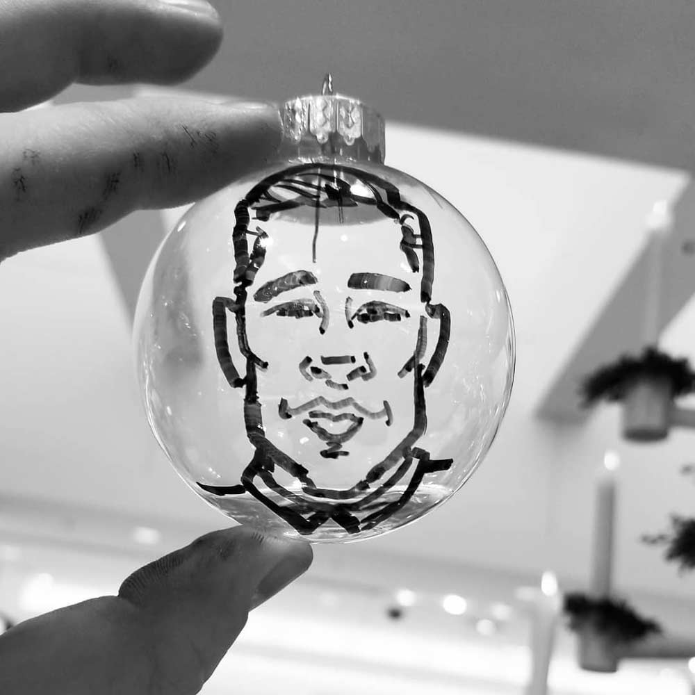 Guests enjoying caricatures at a corporate holiday event